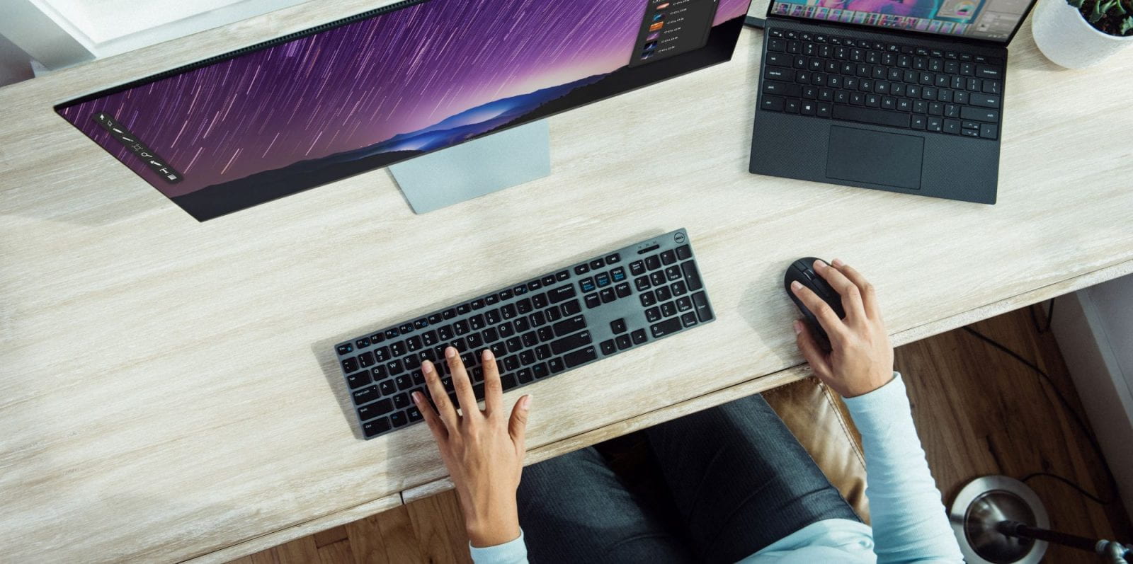 hands on keyboard and mouse in front of computer