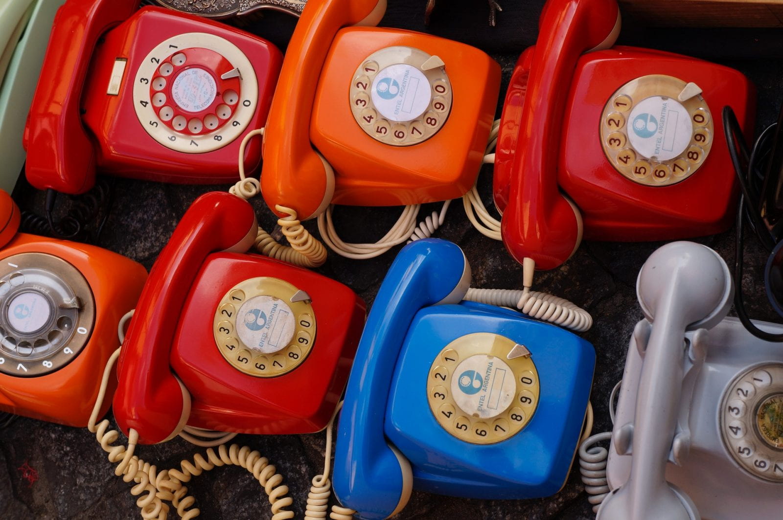 multiple brightly colored rotary-dial phones