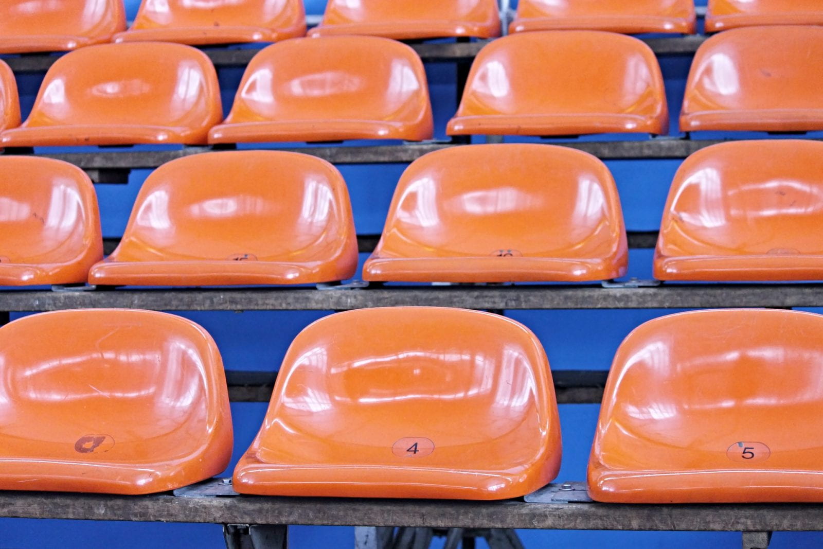 orange stadium seats on blue background