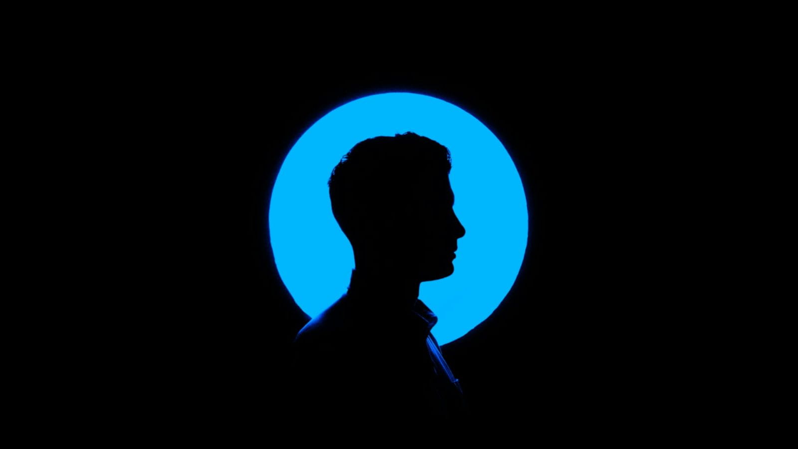 profile view of man's face on blue background